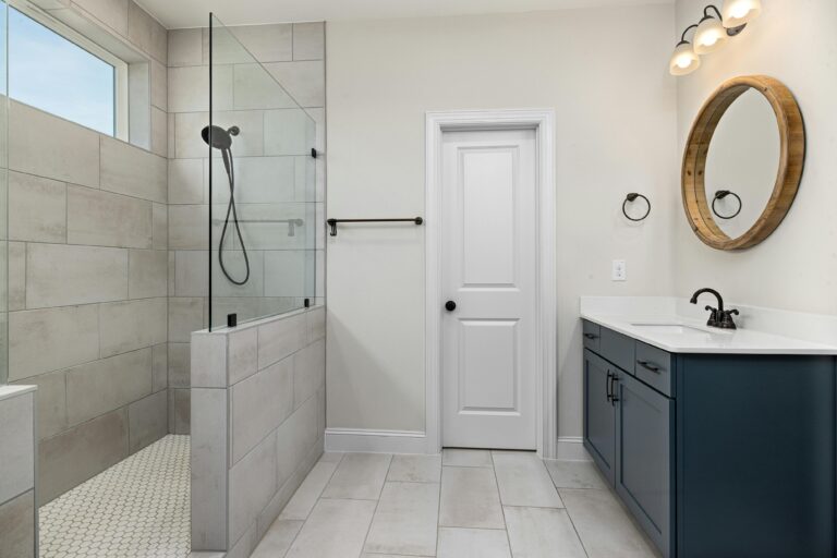 Small bathroom remodel with compact vanity and glass shower