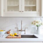 Bright kitchen with white shaker cabinets, hardwood floors, and large windows in a Cary NC residential remodel