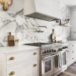 Modern white kitchen with quartz countertops, shaker cabinets, and natural light in a Raleigh North Carolina home remodel