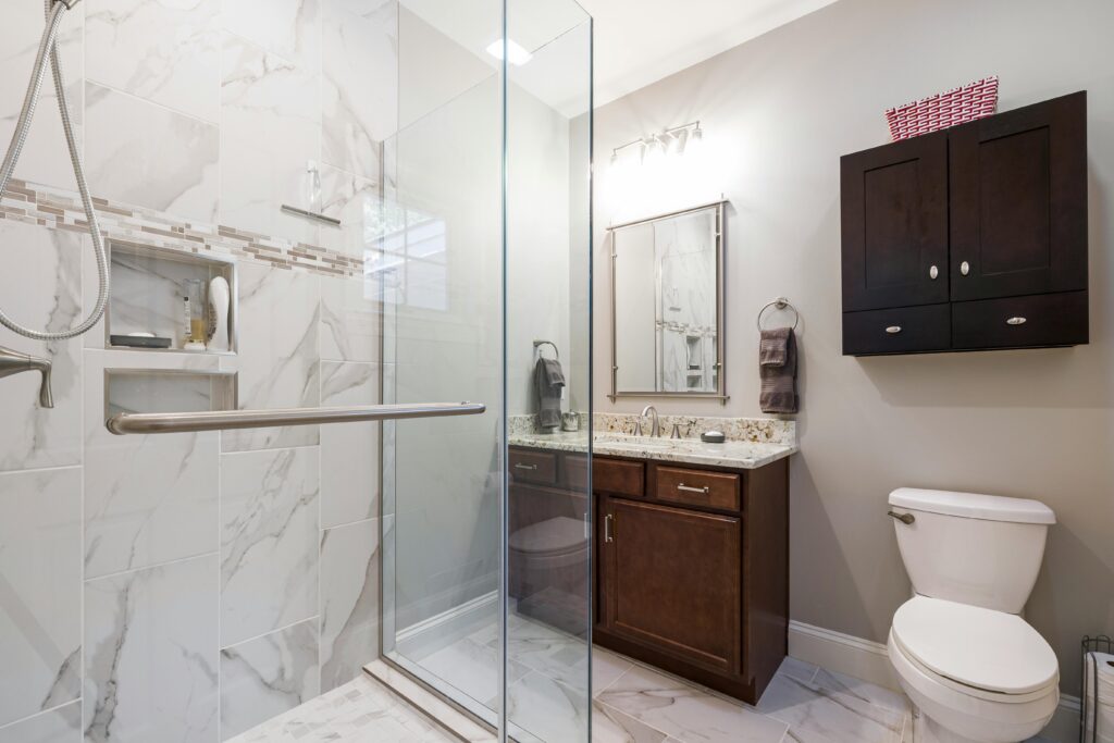 Small bathroom remodel with compact vanity and glass shower