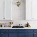 Contemporary kitchen with navy lower cabinets and white upper cabinets in a Cary North Carolina remodel
