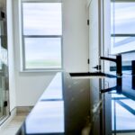 Standard bathroom remodel with frameless glass shower and quartz vanity